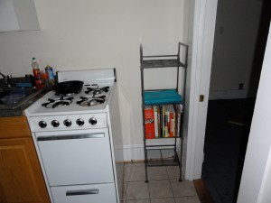Shelf next to stove in kitchen.