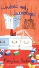 Woman sitting on coffin reading newspaper.