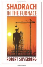 Silhouette of man standing in front of what appears to be an oil rig.