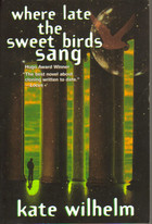 Silhouette of a person standing next to a pillar against a yellowish-green sky.