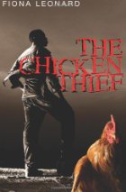 Image of African man standing near a chicken.