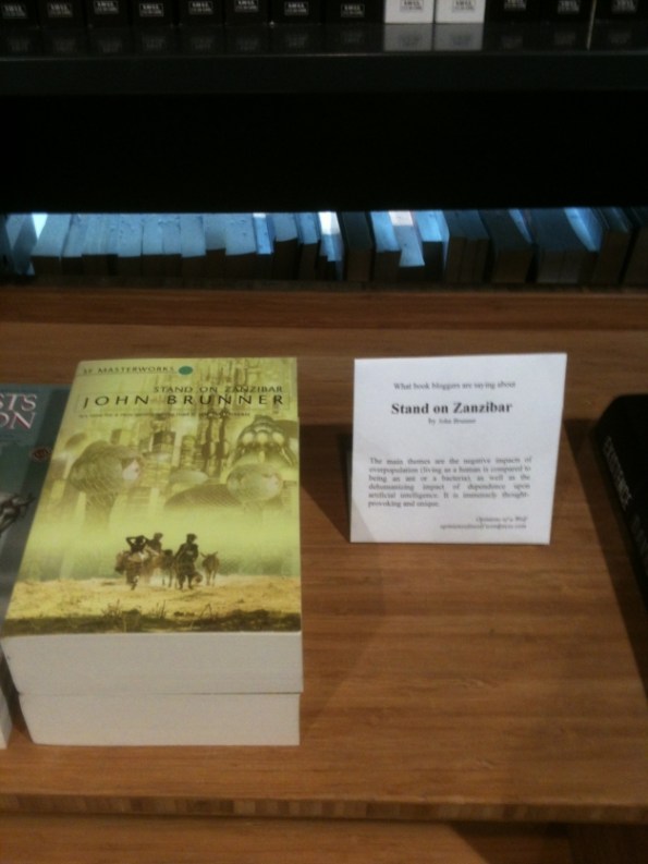 shelftalkerstandonzanzibarabcnl Pile of books with a recommendation placard.