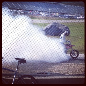 Motard burning out for the crowd on his cool-down lap.