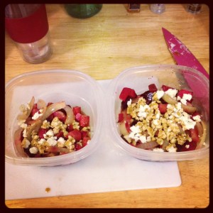 Image of two tupperware containers on a white cuttingboard. The containers contains multicolored salad.
