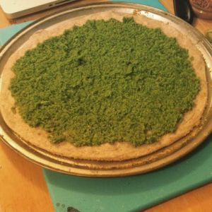 Garlic Scape Pesto on top of my pizza crust, before the rest of the toppings were added.