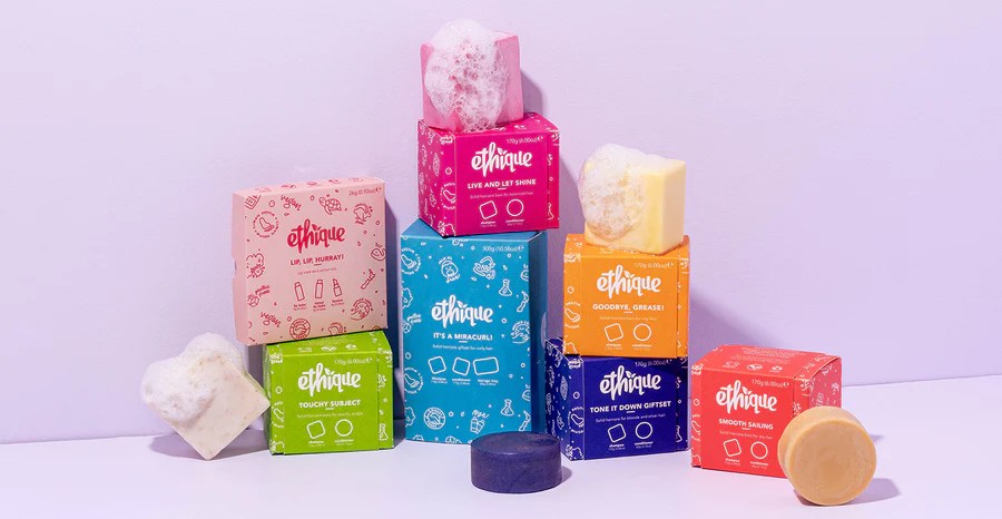 Image of a pile of boxes of soap with some out on top with bubbles coming out of them.