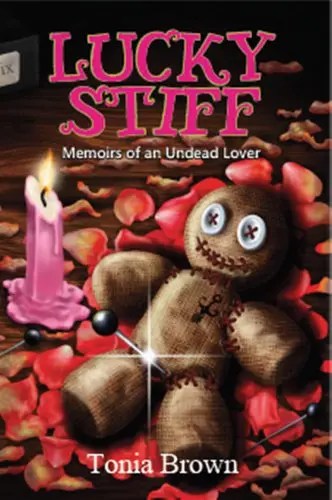 Image of a digital book cover. A voodoo doll lies next to a partially burnt down pink candle.